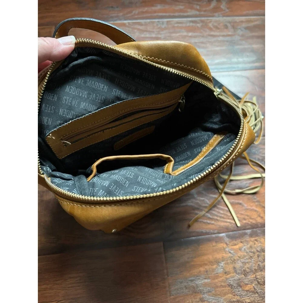 Steve Madden camel-colored Tampa backpack featuring a tassel detail